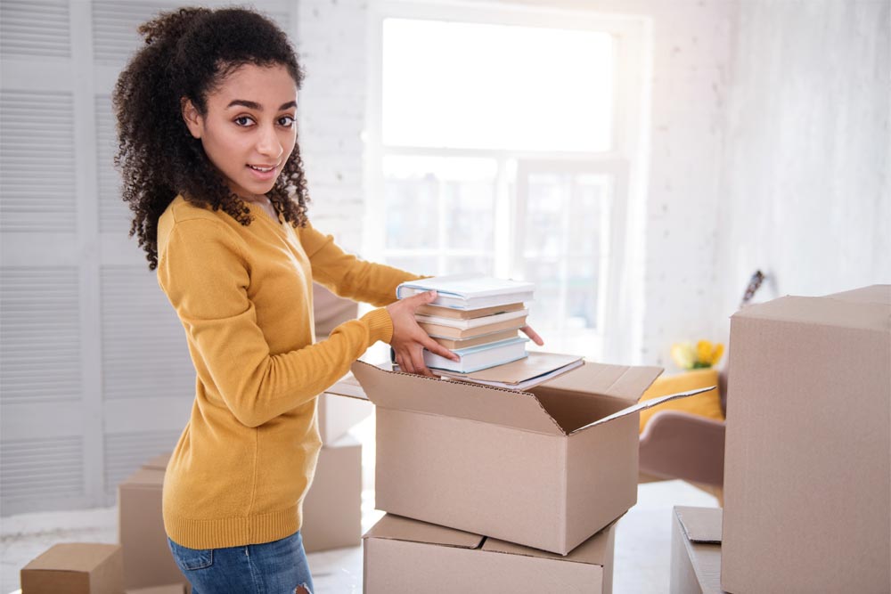 young woman packing to move to college